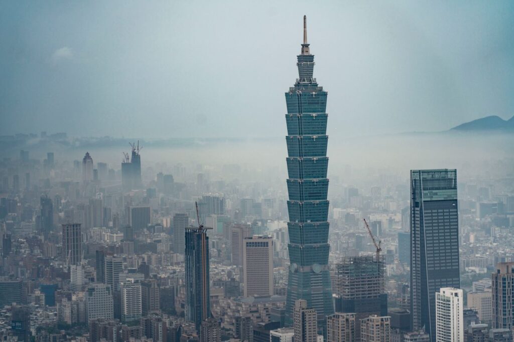 Aerial view of Taipei 101 amidst the urban landscape and foggy skyline in Taipei, Taiwan.